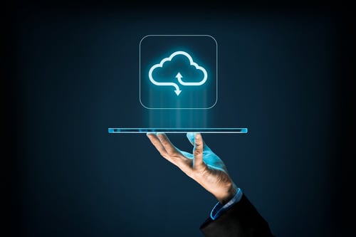 hand holding tablet, with cloud computing icon above it