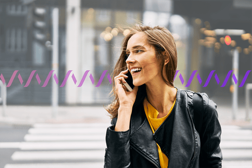 A smiling woman using a mobile phone